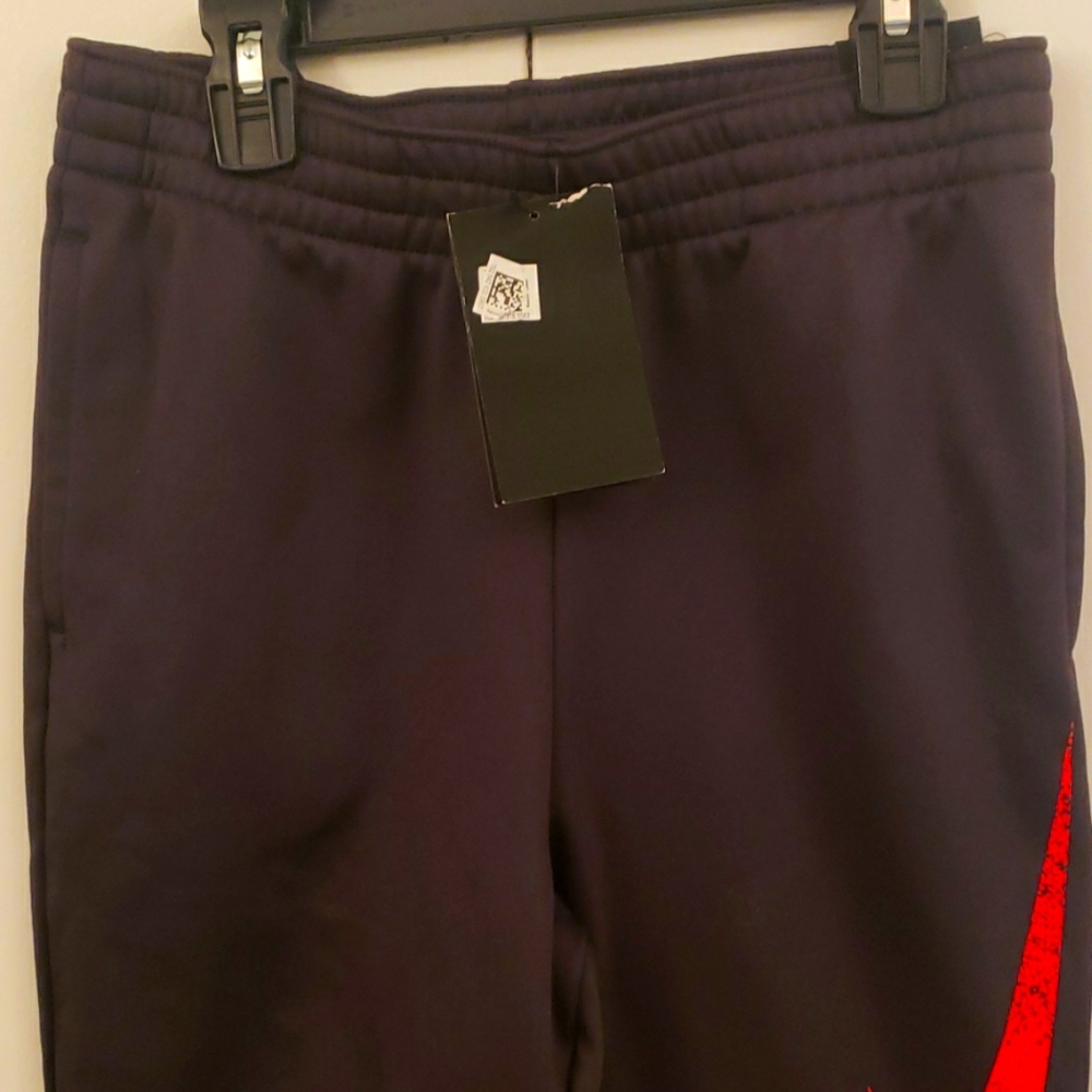 nike dry fit pants for boys gray with an orange nike logo